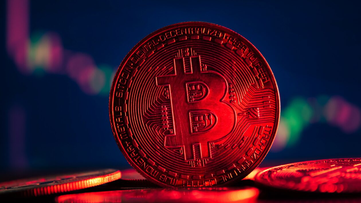Coins with bitcoin symbol on red light and crypto stocks chart, Markets: Bitcoin, Ether slide, crypto market cap drops under US$1 trillion