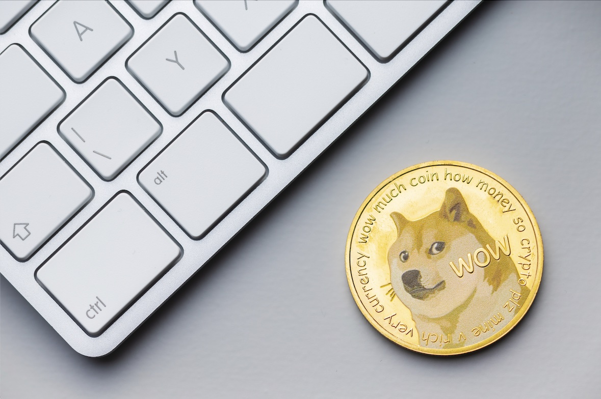 Golden dogecoin coin. Cryptocurrency dogecoin. Doge cryptocurrency and computer keyboard.