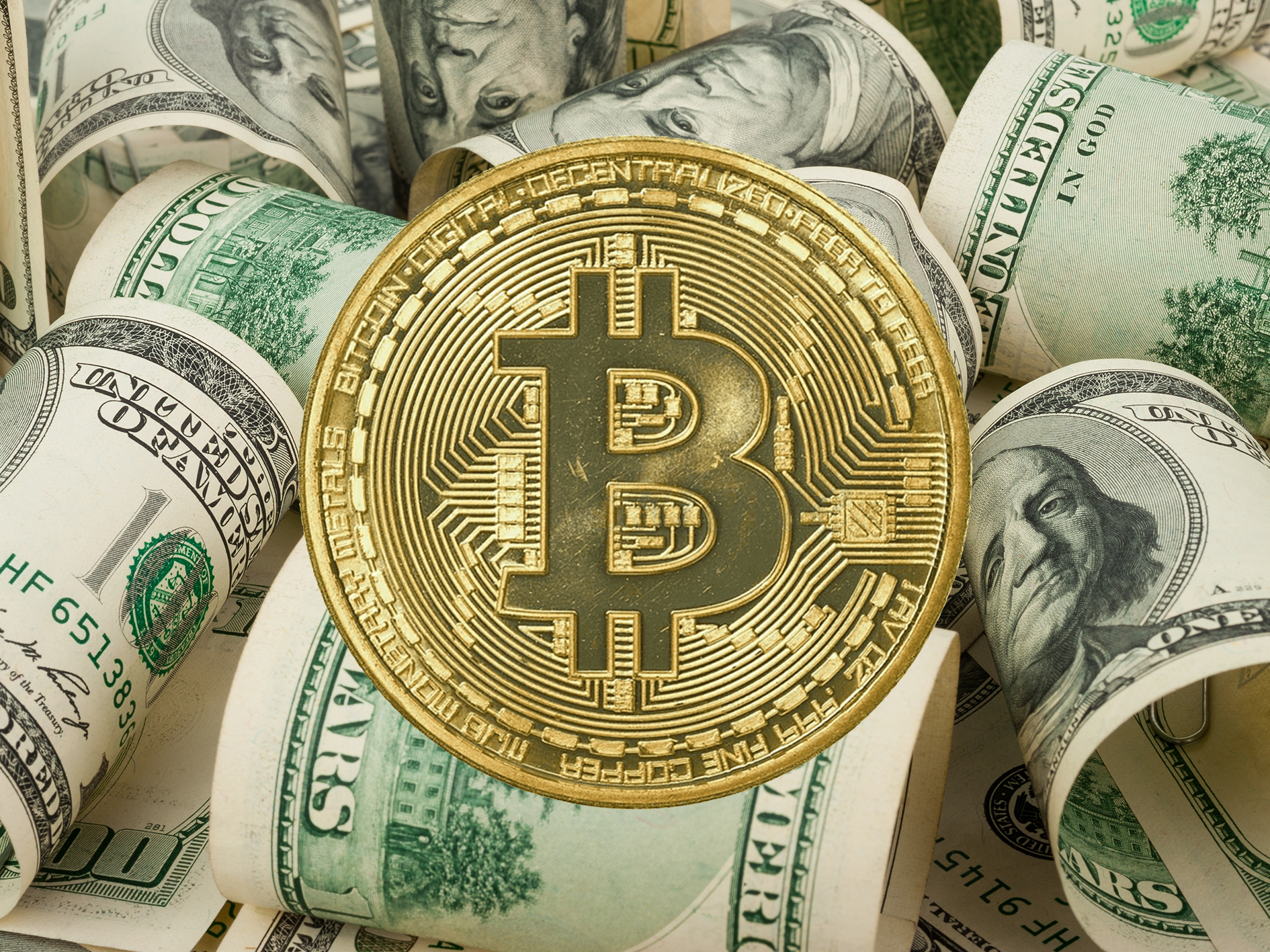 bitcoin gold token and dollar bills